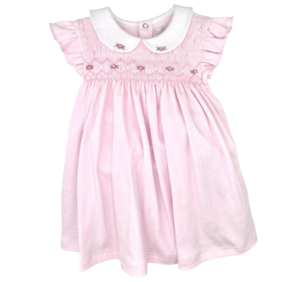 pink dress with full rose smocking and a rounded white collar with two roses on it. 