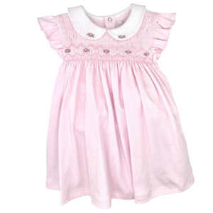 pink dress with full rose smocking and a rounded white collar with two roses on it. 