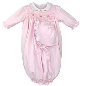 pink long sleeve gown with rose smocking and a white rounded collar with two roses. has a matching bonnet. 