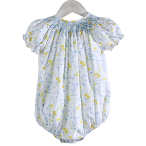 white bubble with yellow and blue flowers with blue smocking on the neckline