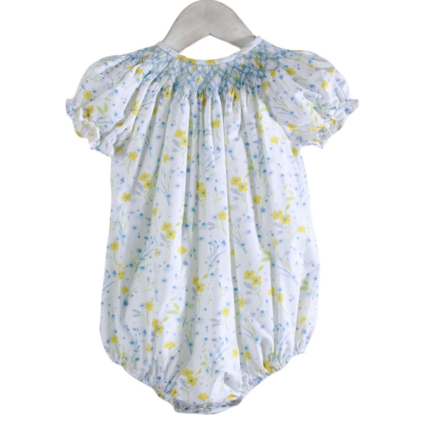 white bubble with yellow and blue flowers with blue smocking on the neckline