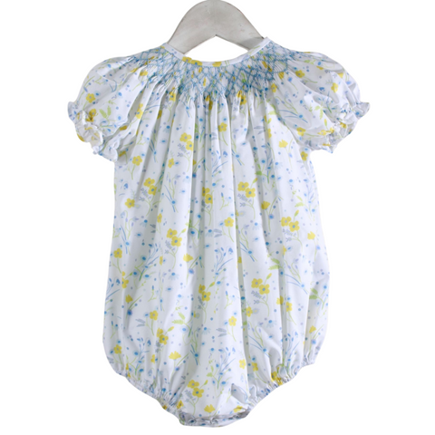 white bubble with yellow and blue flowers with blue smocking on the neckline