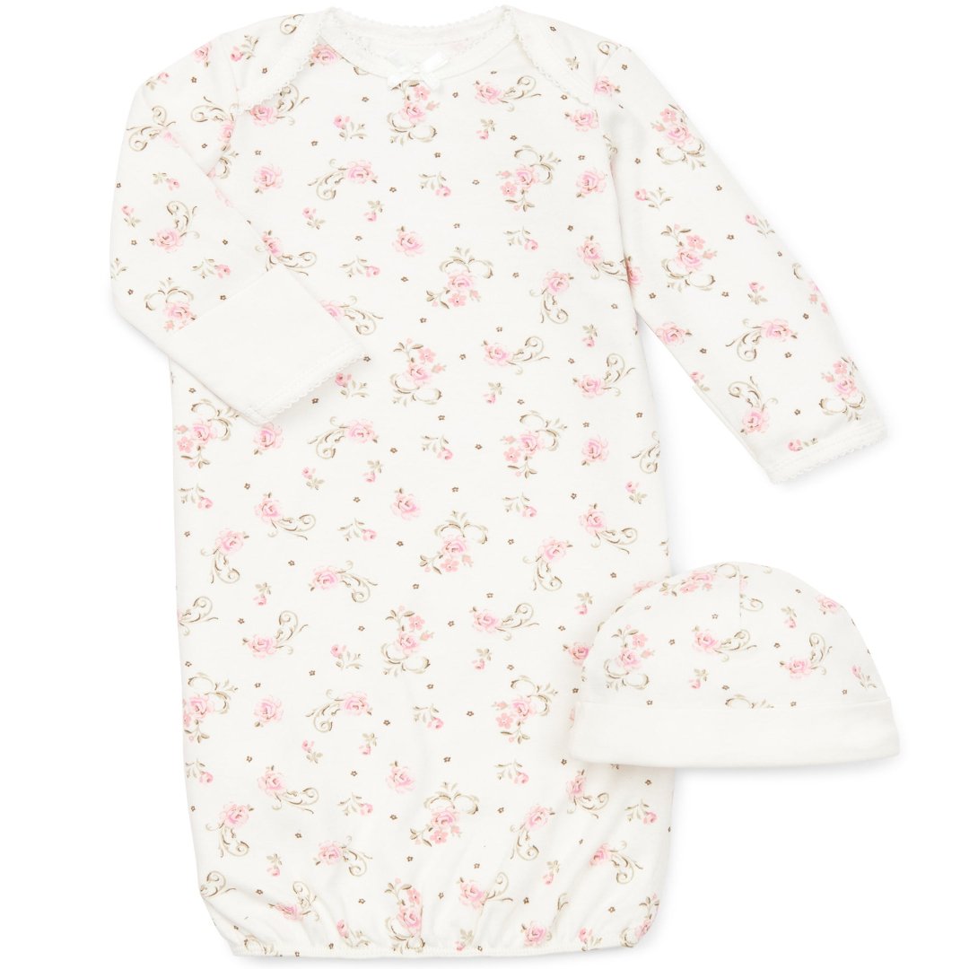 white gown with pink flowers and a matching hat. 